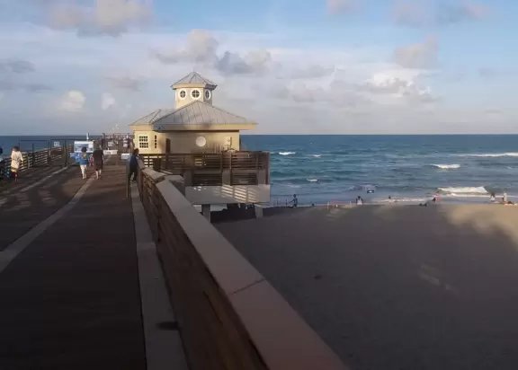 Beach with cute pier and aquamarine water.