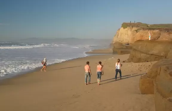 A pretty beach of golden sand and sandstone ledges.