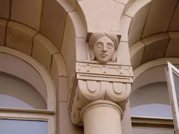 Gorgeous campus with Romanesque Revival architecture, huge sloping lawns, and old trees.