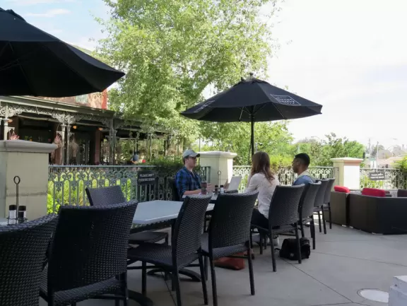 A shopping plaza with sidewalks cafes and shops that would look like Europe if it weren't so new!