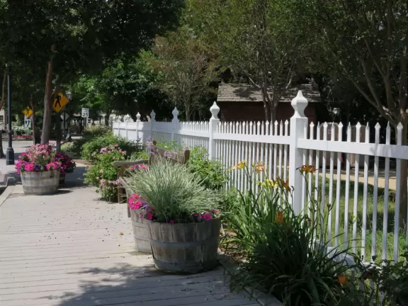 Small park with creek, adobe house, flower baskets, a few shops.