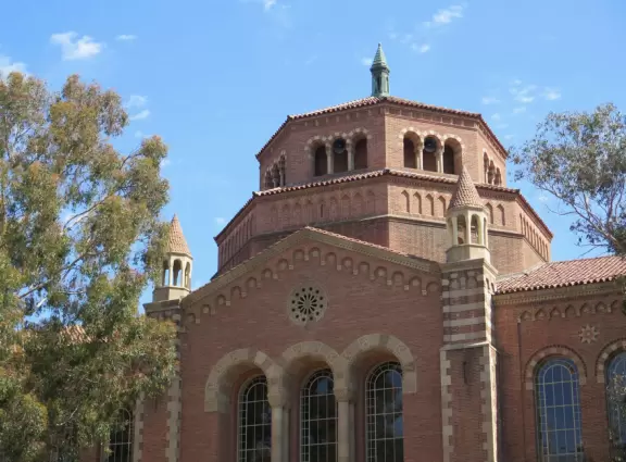 Gorgeous campus with Romanesque Revival architecture, huge sloping lawns, and old trees.