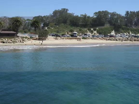 Festive beach with white cliffs, popular playground, pier, and cafe coming soon.