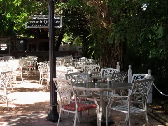 Main block with tropical-themed cafes and views of the water, plus a coffee shop and gift shops in little houses.