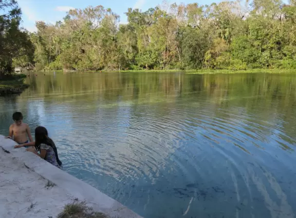 Called a spring, but more like a river, with a small white sand area where kids can play.