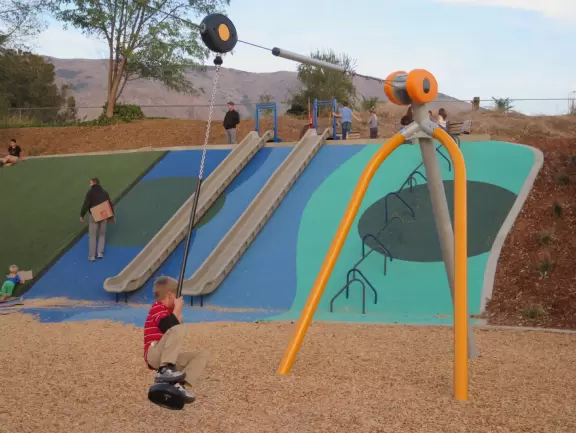 Best playground you'll ever visit! Huge slides, hillside slides, steep grass slope for cardboard sledding, cable zipline, and pretty trees to picnic under.