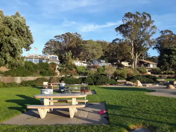 Cement ship playground with logs to climb, seal, dolphin, whale's tail and giant octopus sculptures, picnic tables, and an amazing view of Morro Rock and the inlet.