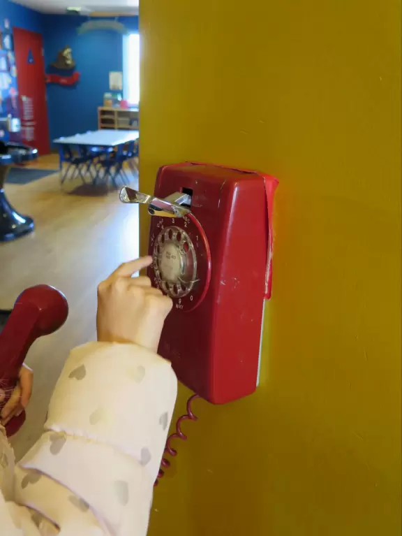 Attractive children's museum with market and carts, Newton's playhouse where you can shoot balls, ball pit, fire engine, oak tree tunnels, stage, dress-up area, and pizza kitchen.