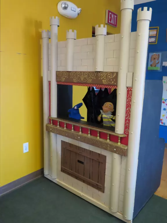 Attractive children's museum with market and carts, Newton's playhouse where you can shoot balls, ball pit, fire engine, oak tree tunnels, stage, dress-up area, and pizza kitchen.