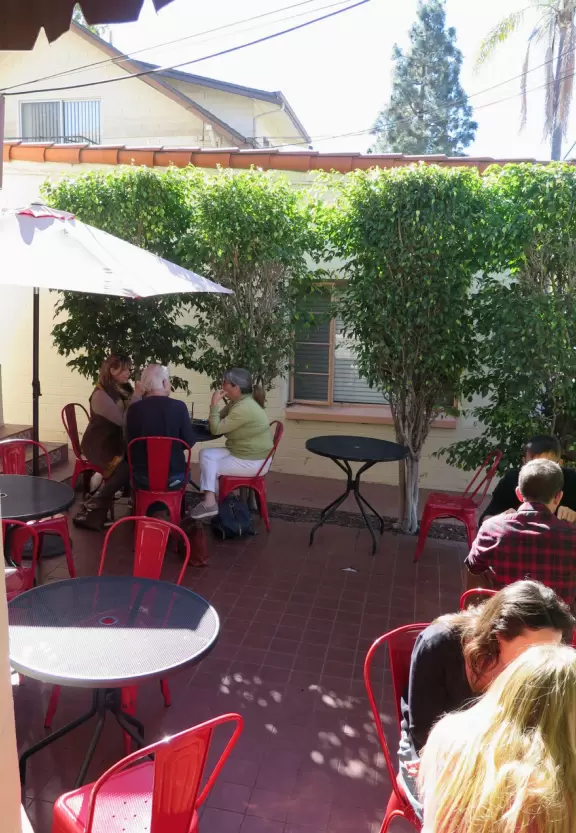 Giant wooden castle playground set among tropical palms.