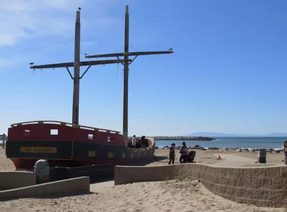 Lovely cove, grassy hills, Spanish galleon ship, playground, walkway out to the point, rocky jetties, and modern beachhouses!