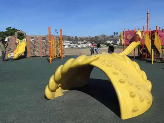 Lovely cove, grassy hills, Spanish galleon ship, playground, walkway out to the point, rocky jetties, and modern beachhouses!