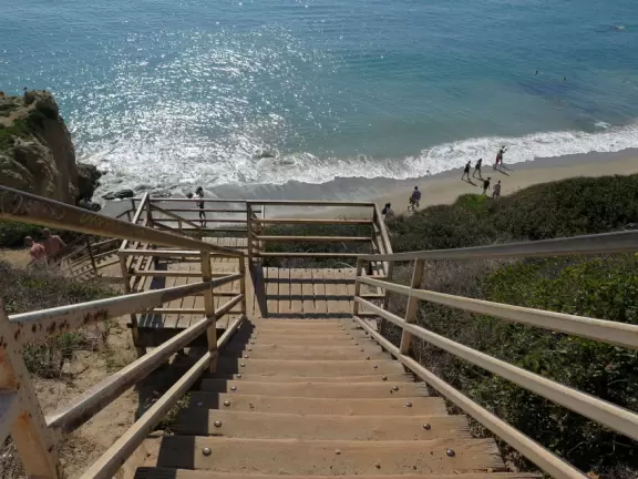 Incredible beach with blue-green water, rocks jutting out of the sea, arches, and caves.