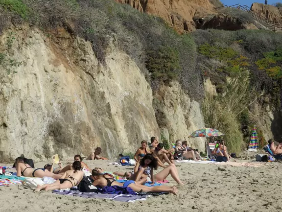 Incredible beach with blue-green water, rocks jutting out of the sea, arches, and caves.