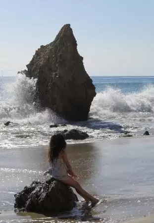 Incredible beach with blue-green water, rocks jutting out of the sea, arches, and caves.