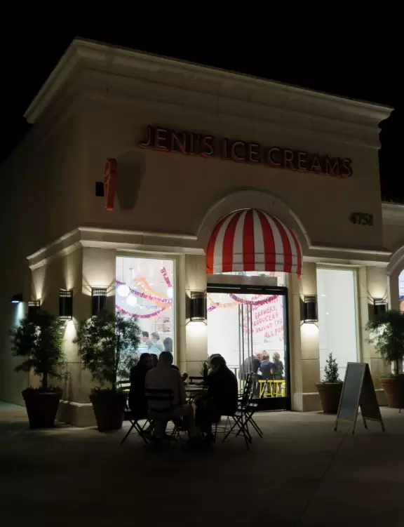 A shopping plaza with sidewalks cafes and shops that would look like Europe if it weren't so new!