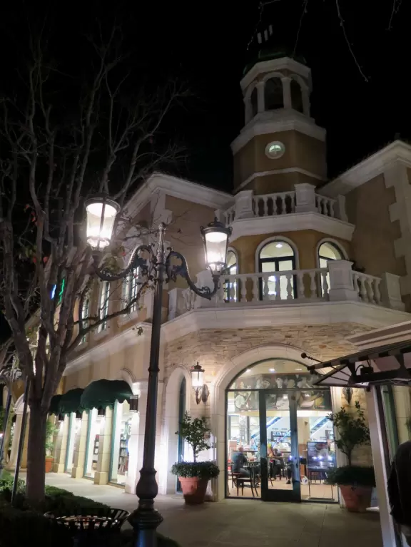 A shopping plaza with sidewalks cafes and shops that would look like Europe if it weren't so new!