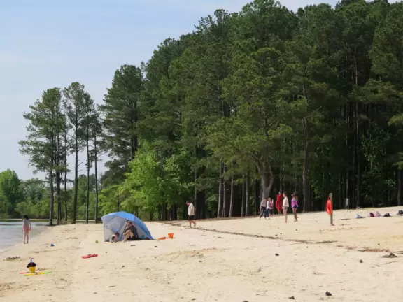 Peaceful&nbsp;spot with nice sand (great for building), blue water (from a distance), the sound of water lapping the shore, green lawn, playground, and trees for shade.