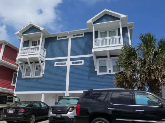 Cute town with pastel-colored beach houses and turquoise horizon.