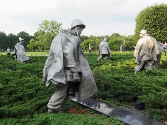 Memorial full of atmosphere, with statues of soldiers rising out of the juniper bushes.