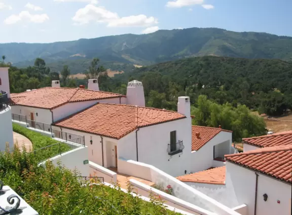 A magical place set upon hills with huge majestic oaks, shimmering green lawns, and exquisite Spanish architecture and decor, all backed by Ojai's mountains.