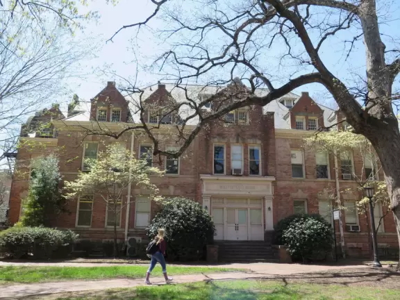 Historic buildings, sunny quad where students hang out, flowers and old trees, and fun student center area.