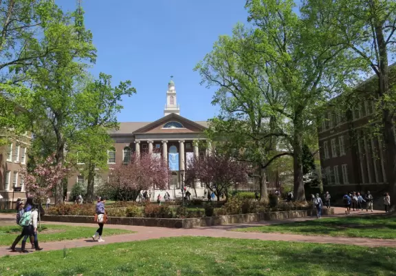 Historic buildings, sunny quad where students hang out, flowers and old trees, and fun student center area.