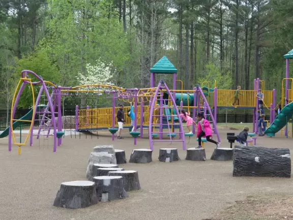 Awesome playground with lots of structures and little hill to play on.