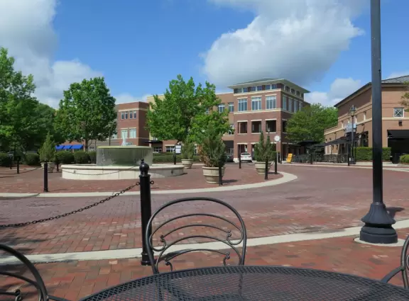Lovely development with brick buildings, outdoor cafes in the sun, and a fountain, plus a great bike path nearby.