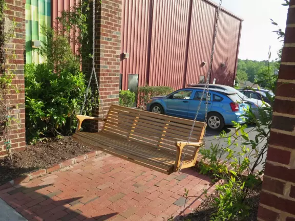 Cute area with outdoor cafes, flower boxes, church steeple with chimes, and village green&nbsp;where family events such as movie night or games night are held.