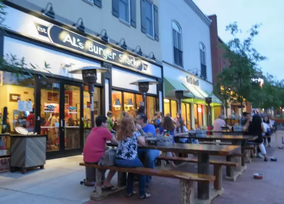 Cute area with outdoor cafes, flower boxes, church steeple with chimes, and village green&nbsp;where family events such as movie night or games night are held.
