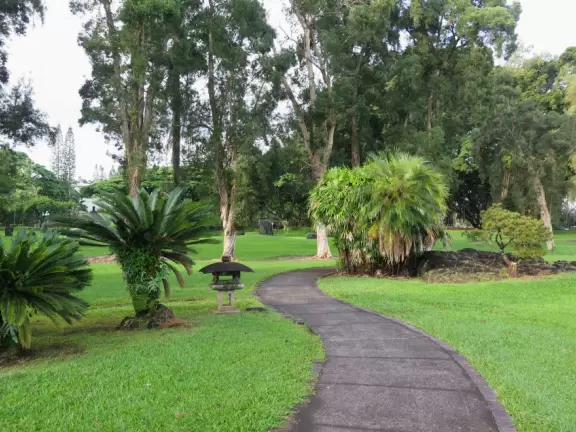 Green, green&nbsp;gardens with Japanese bridges and ponds, and views of silvery Hilo Bay and Mauna Kea.