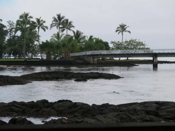 Green, green&nbsp;gardens with Japanese bridges and ponds, and views of silvery Hilo Bay and Mauna Kea.
