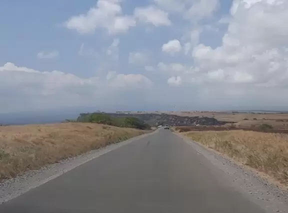 Barren, exposed, windy area where people jump off cliff and then climb a rusty, windwhipped ladder back up.