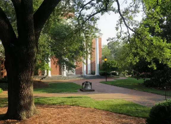 Historic buildings, sunny quad where students hang out, flowers and old trees, and fun student center area.