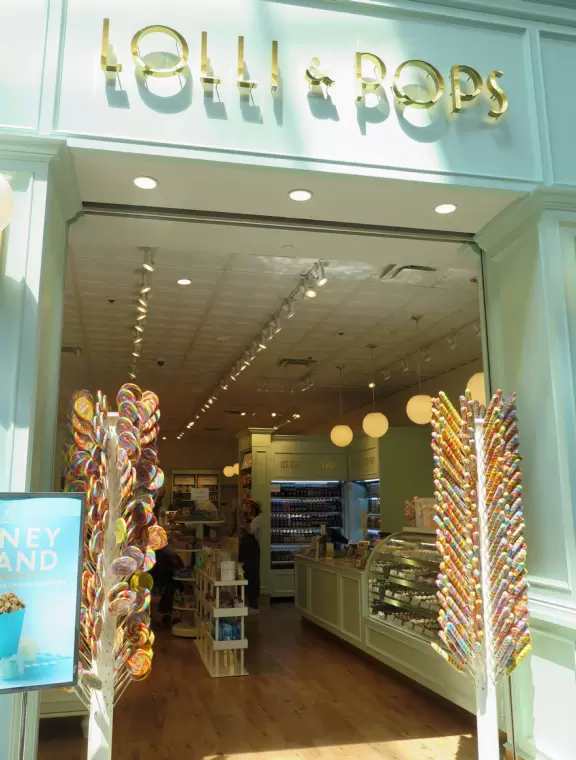 Upscale mall with indoor section like colorful streets and outdoor section with sidewalk cafes.