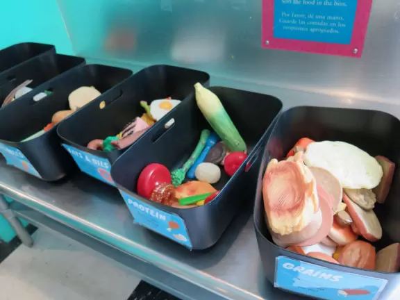 Large children's museum with ship with cannons, play houses, market and diner.