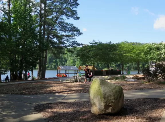Beautiful lake with small beach, kayak rentals, and 3 mile shady paved&nbsp;walking loop around the lake.
