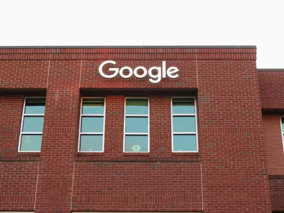 Cute downtown area with big trees, sidewalk cafes, and brick buildings.
