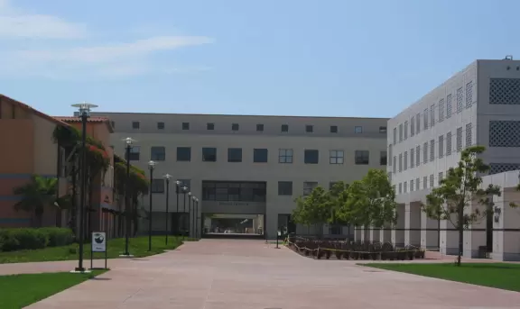 A walk past grassy knolls, a shimmering lagoon, and picturesque bluffs above the ocean, all in the vibrant atmosphere of campus!