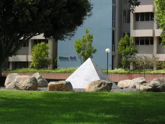 A walk past grassy knolls, a shimmering lagoon, and picturesque bluffs above the ocean, all in the vibrant atmosphere of campus!