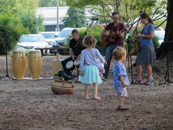Health food store with great bakery, indoor seating with&nbsp;big windows, and outdoor picnic tables under thick leafy shade.