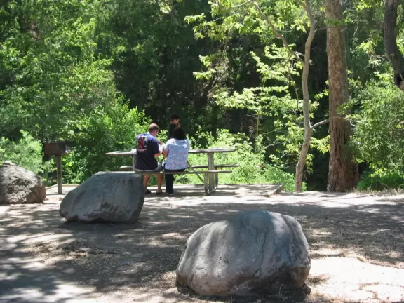 Wooded park with lots of private picnic areas, a playground, a flowing creek, wonderful boulders for kids to climb, and a short hike.