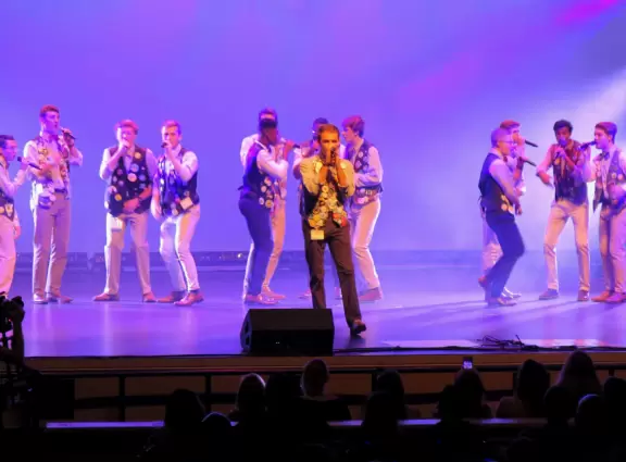 Historic buildings, sunny quad where students hang out, flowers and old trees, and fun student center area.