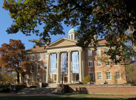 Historic buildings, sunny quad where students hang out, flowers and old trees, and fun student center area.