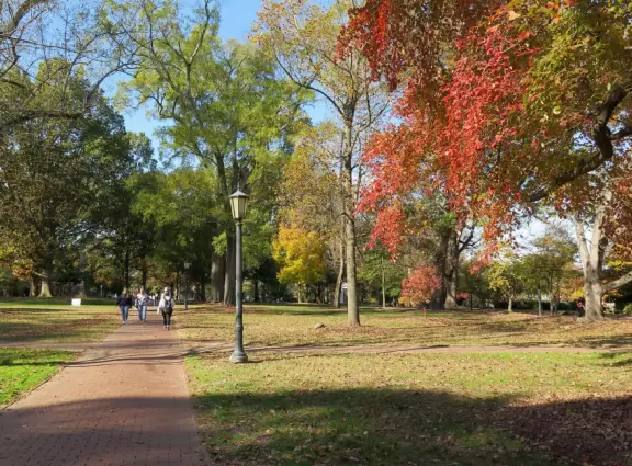 Historic buildings, sunny quad where students hang out, flowers and old trees, and fun student center area.
