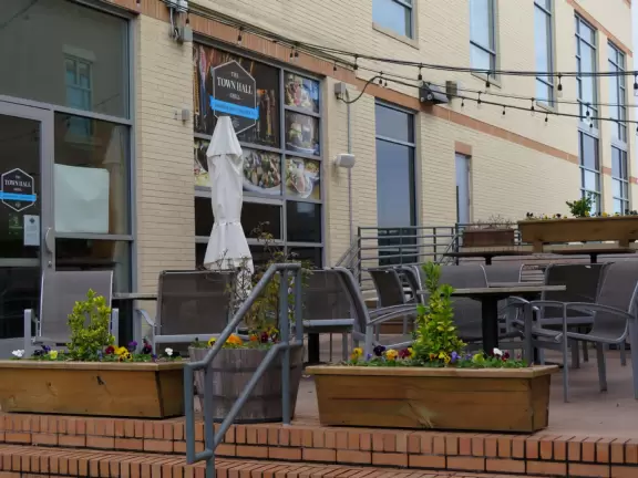 Cute area with outdoor cafes, flower boxes, church steeple with chimes, and village green&nbsp;where family events such as movie night or games night are held.