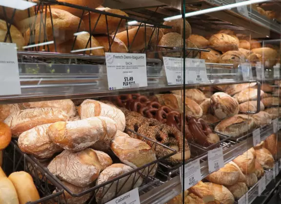 Health food store with great bakery, indoor seating with&nbsp;big windows, and outdoor picnic tables under thick leafy shade.
