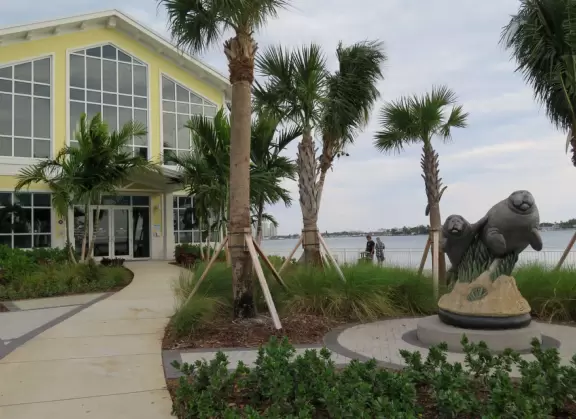 Two-level modern winter manatee viewing center with walkway by the water.