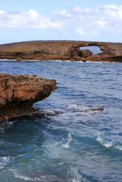 The natural sea arch as seen from rugged La'ie Point.